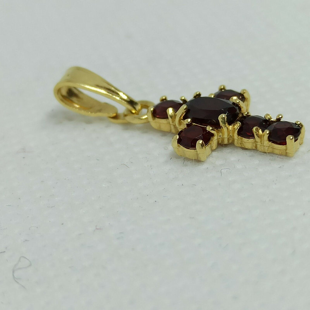 Croce in oro giallo  18 kt pendente con granato.