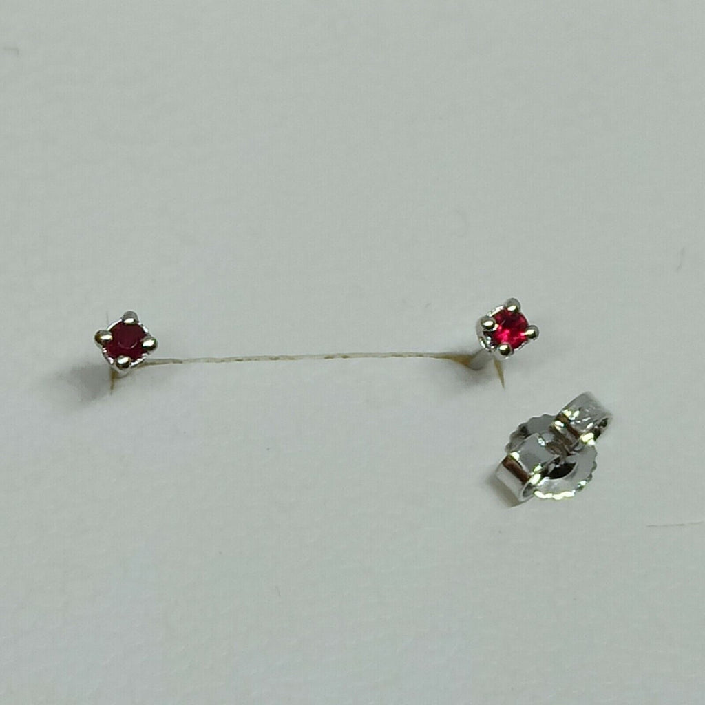 Orecchini punto luce in oro bianco  18 kt  con rubino ct 0,20.